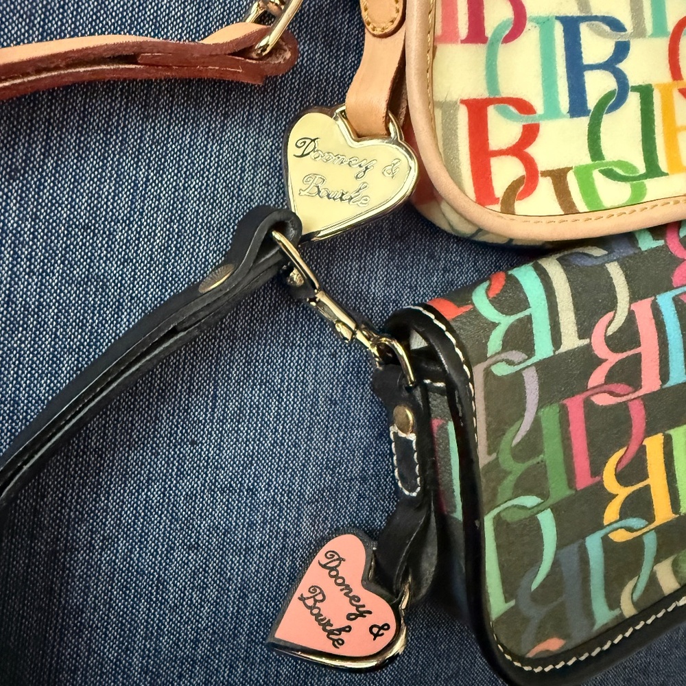 Two NWOT Dooney & Bourke east west wristlets.  One black, one ivory.